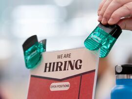 <p>Hiring signage displayed at a job and resource fair</p>