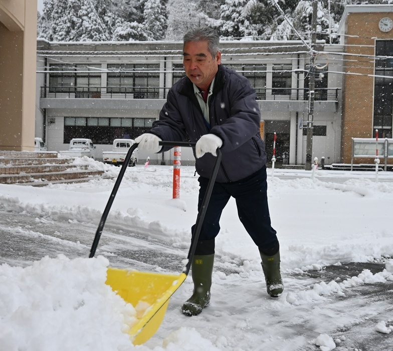 雪をかくまちづくりセンターの職員＝９日午前８時５０分ごろ、浜田市弥栄町長安本郷