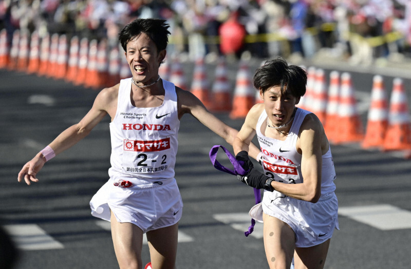 第2中継所でたすきをつなぐ、Hondaの小山直城（左）と伊藤達彦＝群馬県伊勢崎市で2025年1月1日、藤井達也撮影