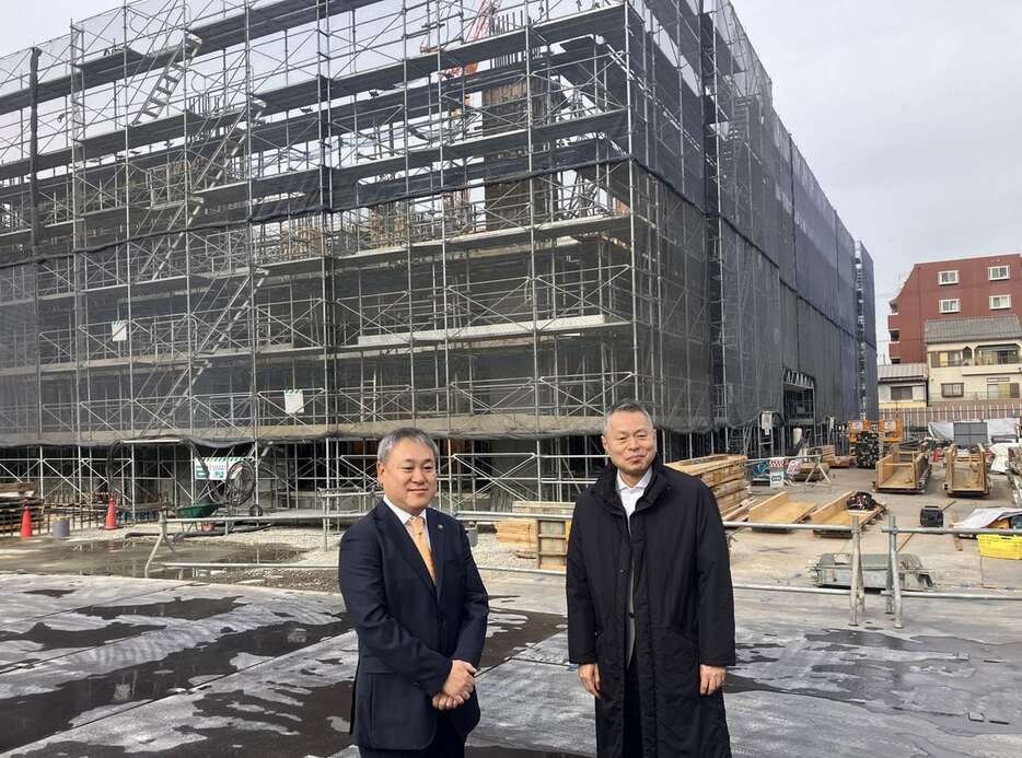 タワマンの建設現場で再開発事業について説明する門真市の宮本一孝市長（左）と住友不動産関西支店長の細川隆司氏＝大阪府門真市