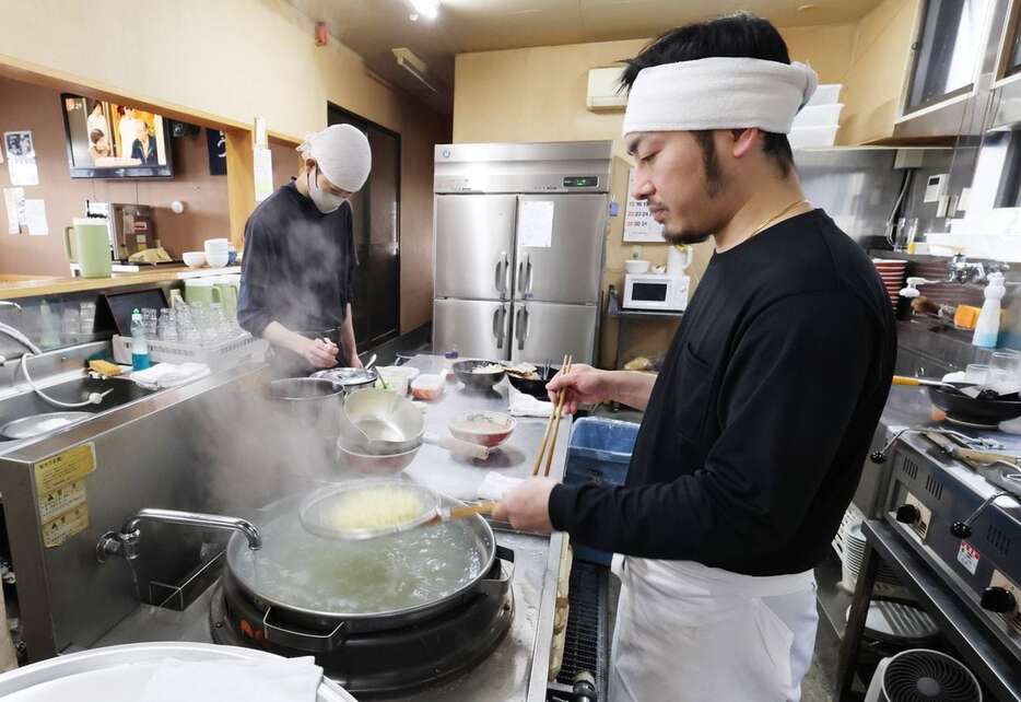 「らーめん一平」で腕を振るう小枝敏樹社長（右）。朝8時前の厨房は慌ただしかった＝福島県喜多方市（芹沢伸生撮影）