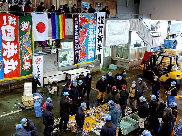 「謹賀新年」の垂れ幕や大漁旗が彩る中で行われた初競り