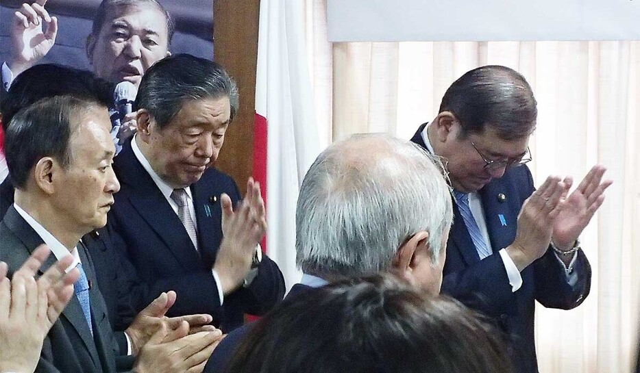 自民党の仕事始め式に出席し拍手する（奥右から）石破首相、森山幹事長、菅副総裁＝７日、党本部