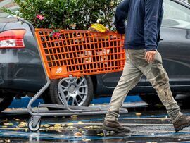 <p>A customer pulls a shopping cart outside a Home Depot store in Palo Alto, California, US</p>