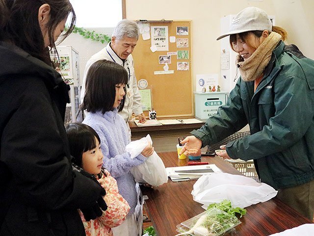 「春の七草」を受け取る来園者＝県自然博物園ねいの里