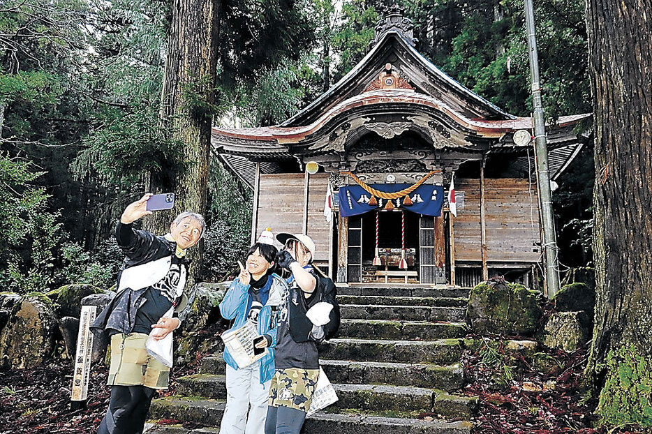 チェックポイントで撮影をする参加者＝富山市八尾町東新町の若宮八幡社