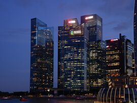 Signage for DBS Group Holdings Ltd. atop buildings in Singapore. Photographer: Ore Huiying/Bloomberg