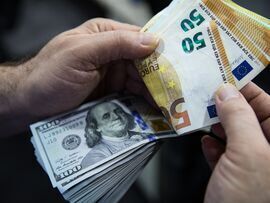 U.S. dollar banknotes and euro banknotes. Photographer: Kerem Uzel/Bloomberg