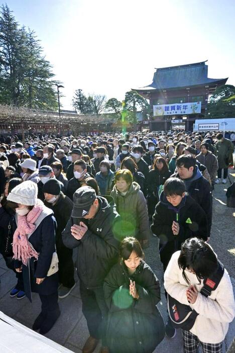 初詣に訪れ、願いを込め手を合わせる参拝客=1日午前、笠間市笠間の笠間稲荷神社