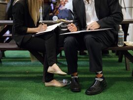 Job seekers review notes during a career fair in Los Angeles. Photographer: Patrick T. Fallon/Bloomberg