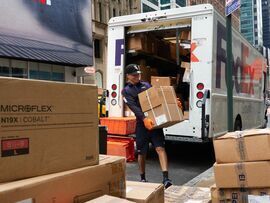 Workers unload packages from a delivery truck in New York.