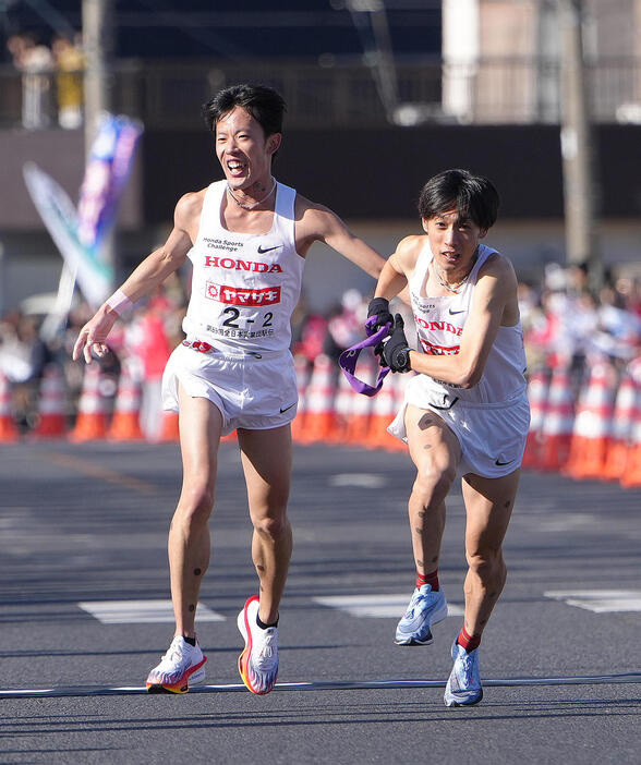 第2中継所でタスキリレーするホンダの2区小山（左）と3区伊藤（撮影・足立雅史）