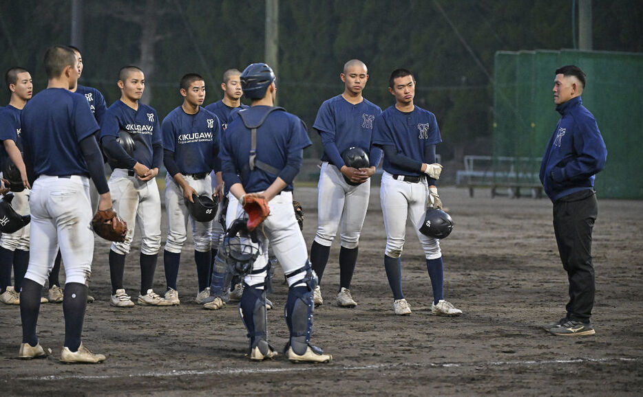 センバツに向けて石岡監督（右）から指導を受ける常葉大菊川ナイン＝菊川市の同高校野球場