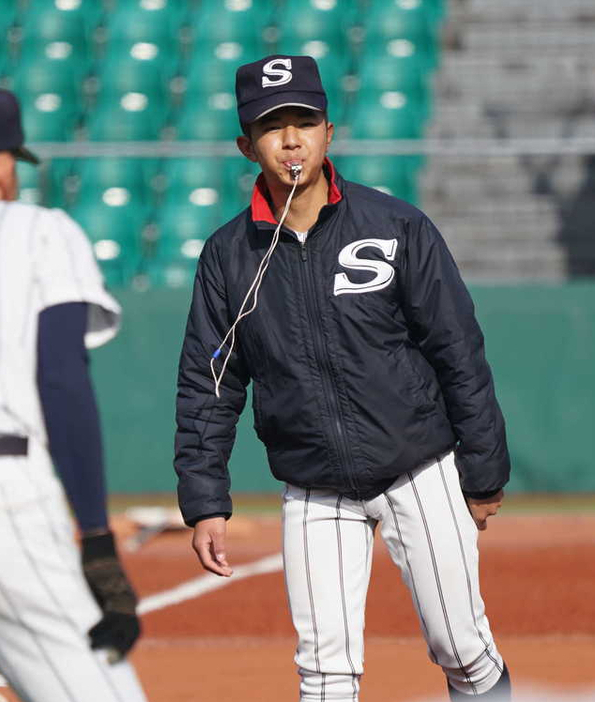 ダッシュの笛を吹く石田琉星学生コーチ＝三次市のみよし運動公園野球場で２０２１年１月３０日午後２時１３分、中島昭浩撮影