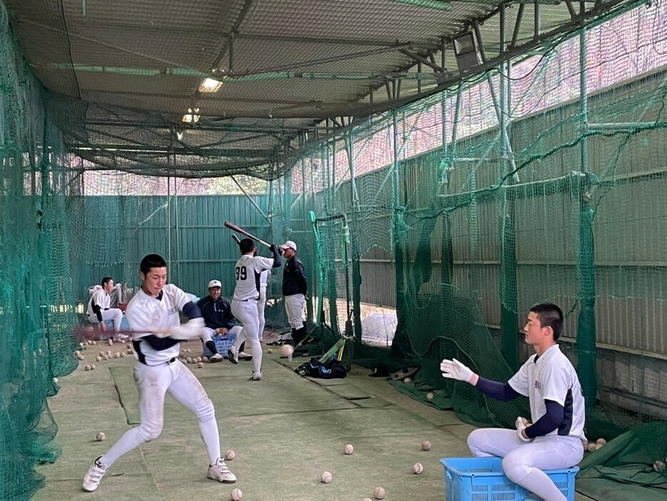 打撃練習に励む近江の選手たち＝奈良県香芝市の大阪商業大の室内練習場で、同高提供