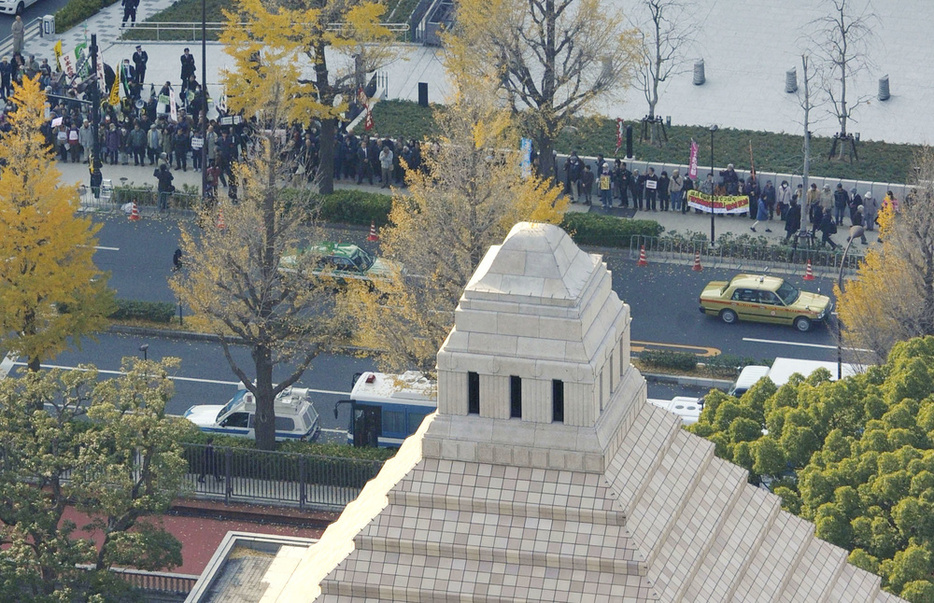 特定秘密保護法案に反対し、国会議事堂（手前）周辺に集まった人たち＝2013年12月4日