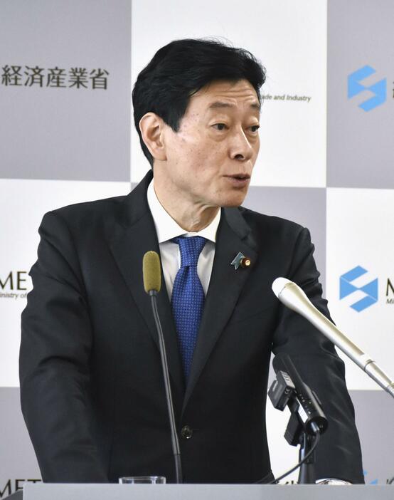 記者会見する西村経産相＝8日午前、経産省