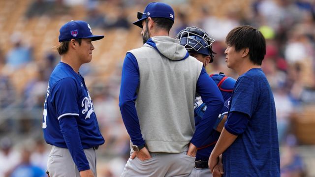 ドジャースのオープン戦でマウンドの山本由伸投手の通訳を行う水原一平氏(写真：AP/アフロ)