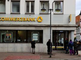 Customers wait to enter a Commerzbank bank branch in Frankfurt, Germany. Photographer: Alex Kraus/Bloomberg