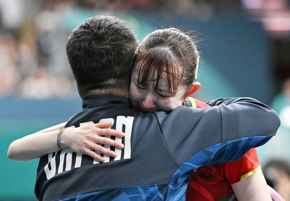 パリ五輪卓球女子シングルスで銅メダルを獲得し、石田コーチ（手前）と抱き合って喜ぶ早田ひな（撮影・中村太一）