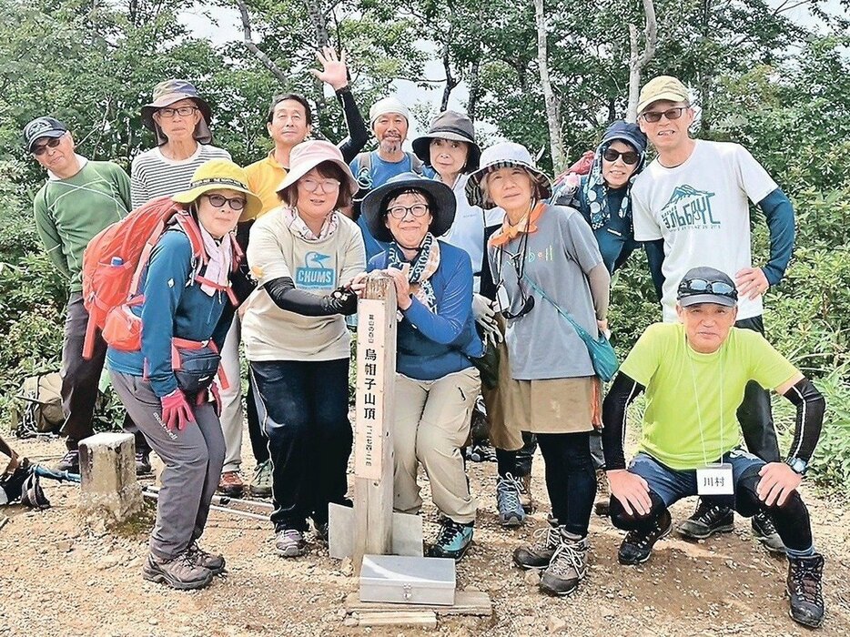 ８月２４日の山行で、山頂で記念撮影をする参加者＝烏帽子山