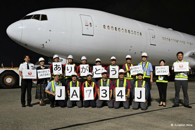 羽田空港出発前の元JAL 777-300ER 4号機JA734Jとパネルを手に記念撮影に応じるJAL社員＝24年9月19日 PHOTO: Tadayuki YOSHIKAWA/Aviation Wire