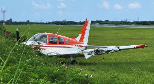 〈資料写真〉６月５日、滑走路を外れて草地に入り、動けない小型機＝与論町立長の与論空港（協力員提供）