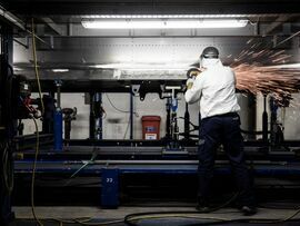 A worker fabricates a part for use in a rail carriage on the production line at a Siemens railway plant.