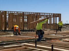 Contractors frame walls on a house under construction in Folsom, California.