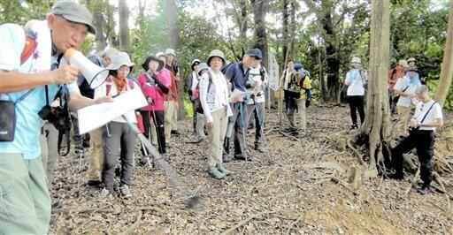 砕導山城の曲輪で案内役の中井さん（左）から遺構の説明を聞く参加者=9月14日、福井県高浜町