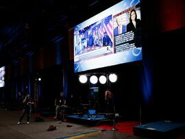 <p> Donald Trump and  Kamala Harris on a screen in the spin room ahead of the second presidential debate.</p>