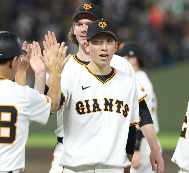 　ヤクルトに勝利し、今季１０勝目を挙げた戸郷はタッチを交わす（撮影・中田匡峻）