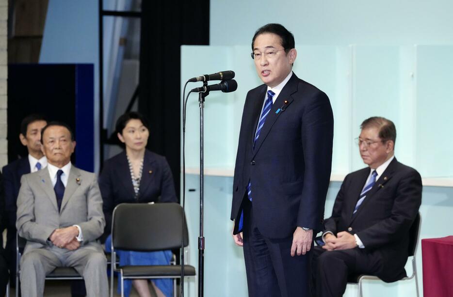 自民党総裁選後に開かれた両院議員総会であいさつする岸田首相。右奥は石破茂新総裁＝27日午後3時33分、東京・永田町の党本部