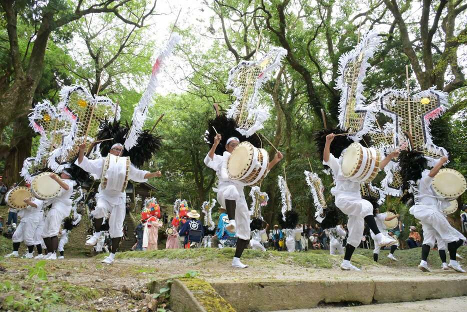 矢旗を背負い、力強く舞う踊り手＝２１日、日置市吹上の南方神社