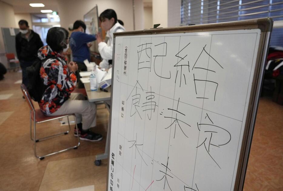 能登半島地震発生翌日の石川県輪島市の避難所で、食事や水の配給が未定であることを知らせる掲示板＝1月