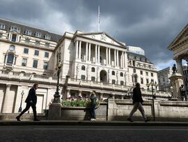 Pedestrians pass the Bank of England in the City of London. Photographer: Hollie Adams/Bloomberg