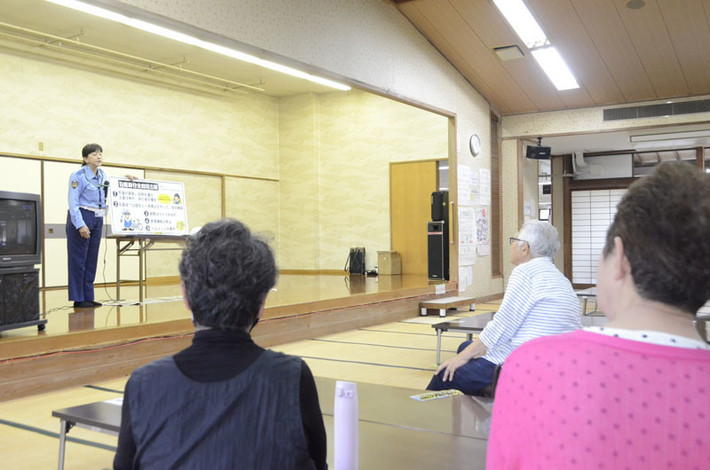 高齢者に交通安全アドバイスをする県警の担当者（左）＝10日、熊谷市