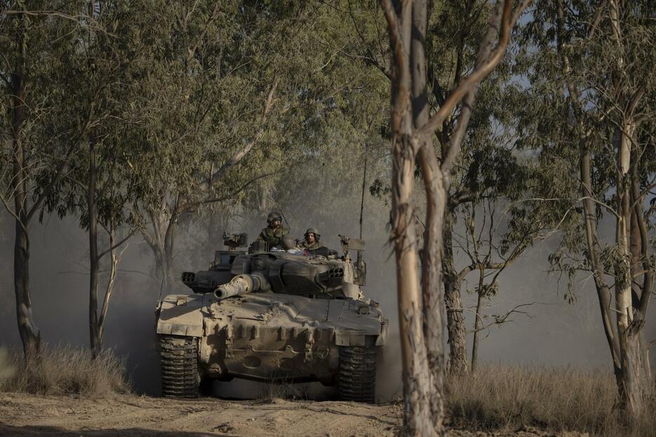 イスラエルとパレスチナ自治区ガザの境界付近を走行するイスラエル軍戦車＝29日（AP＝共同）