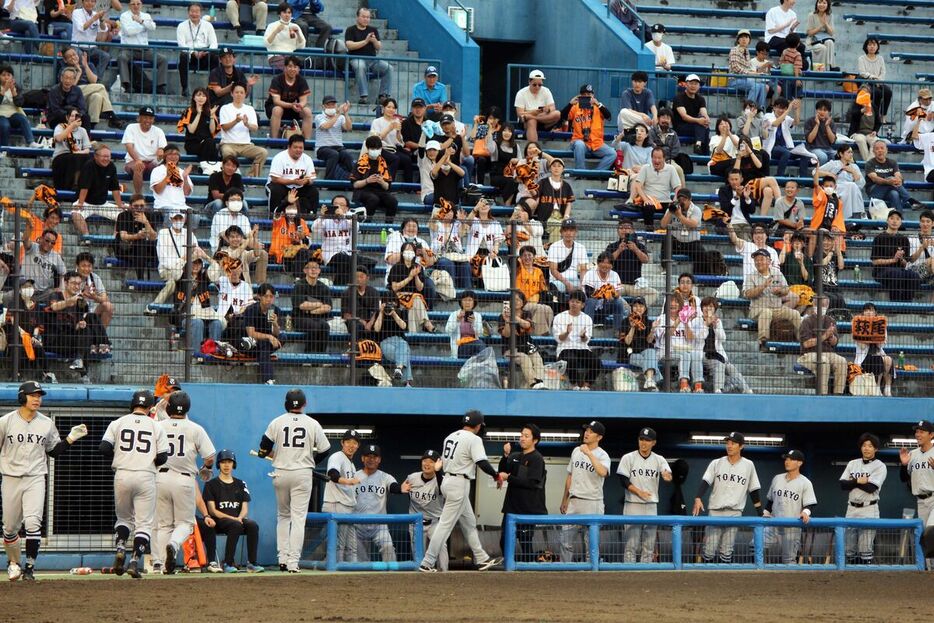 ２回２死満塁、左中間へ満塁本塁打を放った萩尾（１２）をベンチの選手らが出迎え。スタンドに詰めかけた静岡のファンも拍手を送った