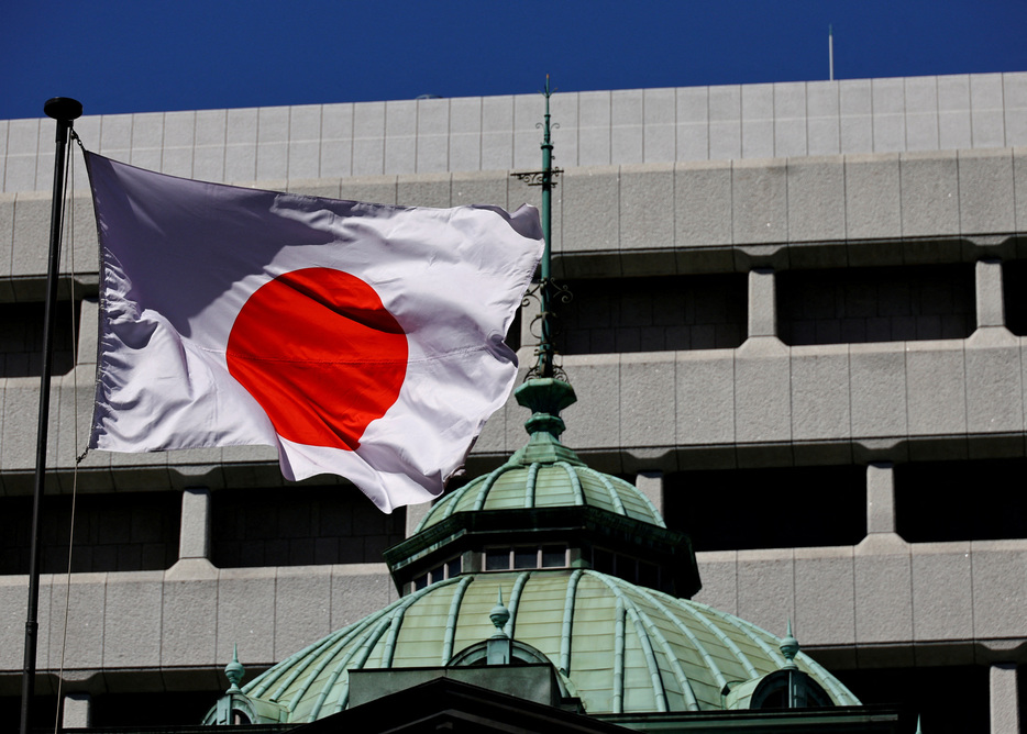 　６月２４日、米格付け会社ムーディーズで日本のソブリン格付けを担当するアナリスト、クリスチャン・ド・グズマン氏は、ロイターとのインタビューに応じ、日本政府が来年度の基礎的財政収支の黒字化目標を達成できなくても、格付けに関してネガティブな見直しをする可能性は低いと述べた。写真は日本の旗。都内の日銀本店前で３月撮影（２０２４年　ロイター/Kim Kyung-Hoon）