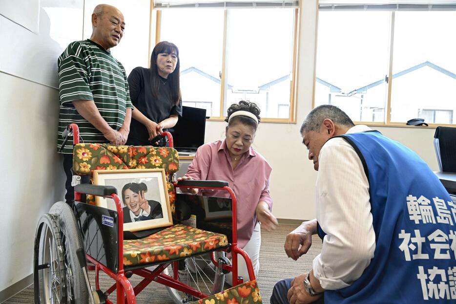 亡き娘の遺志を引き継ぎ、プルタブを集めて購入した車椅子を輪島市社会福祉協議会へ寄贈した（左から）木村喜隆さん、美奈子さん夫妻＝14日午前、石川県輪島市