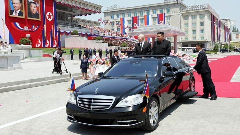 平壌での歓迎式典で高級車に乗るロシアのプーチン大統領と北朝鮮の金正恩総書記
