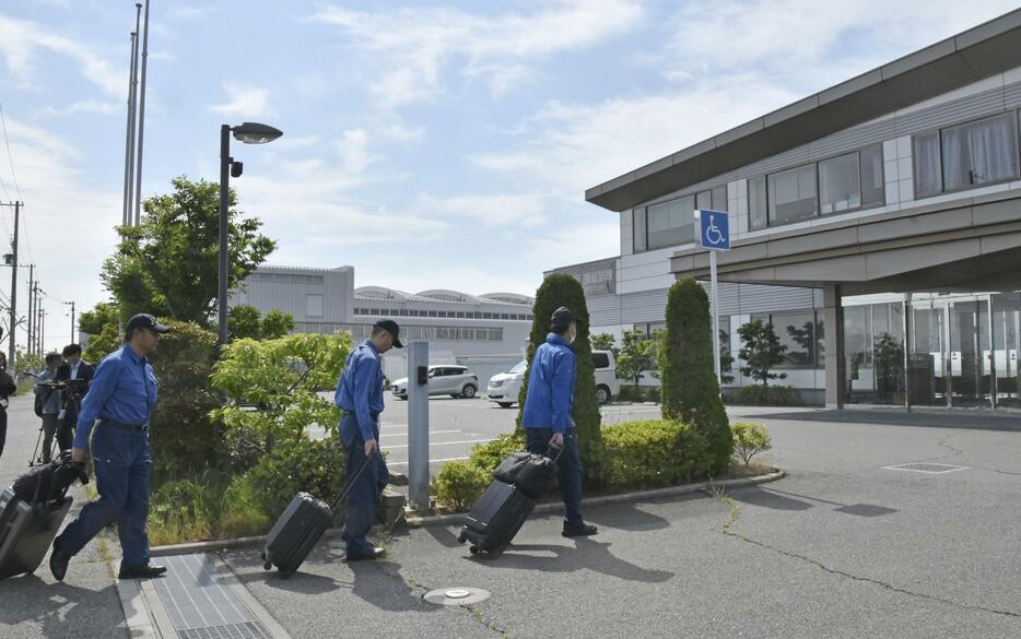 ヒラタ学園航空事業本部に入る航空事故調査官＝1日午前、神戸市