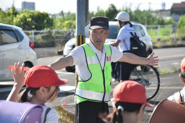 通学路に立ち、児童の見守りを続ける平和が丘自治会の時任孝俊会長＝宮崎市池内町