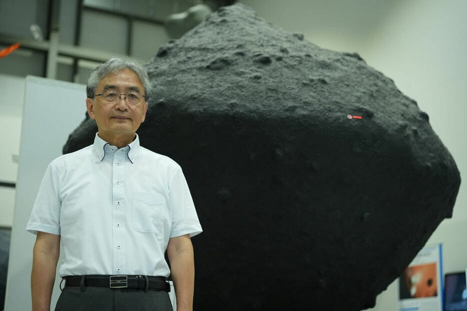JAXA宇宙科学研究所の吉川真さん。後ろに写っているのは小惑星リュウグウの模型。JAXA相模原キャンパスにて2024年6月13日に撮影