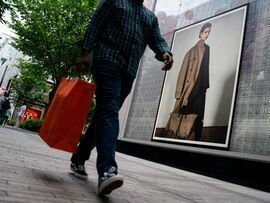 <p>A shopper carries a bag past a storefront in Washington, DC, May 30, 2024. </p>