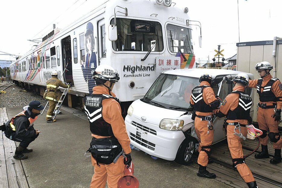 電車と衝突した軽自動車からの救出訓練をする消防隊員