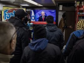 People watch television as Benjamin Netanyahu announces a ceasefire near Martyrs Square in Beirut, Lebanon, on Nov. 26.