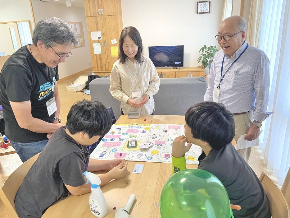 子どもの権利について学びながらすごろくを楽しむアドボケイトと子どもたち＝10月中旬、浜松市中央区の児童養護施設「わこう」