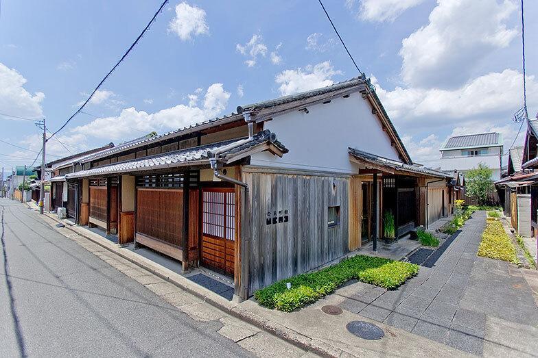 「紀寺の家」全景。左側の道路に面する2戸と右手の路地奥の2戸が1棟の町家を構成する。右手奥の向かい側に戸建ての1棟が並ぶ（写真：出合コウ介）